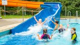 Water slide at Beckum open-air pool with children