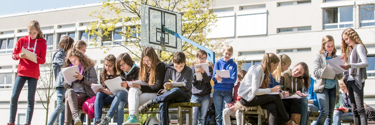 Group of pupils in front of the school