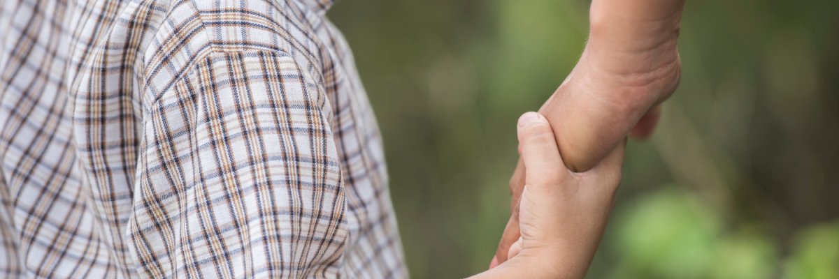 Child at the hand of an adult