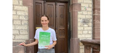 A Woman Presents the Book Child Protection in the District of Warendorf