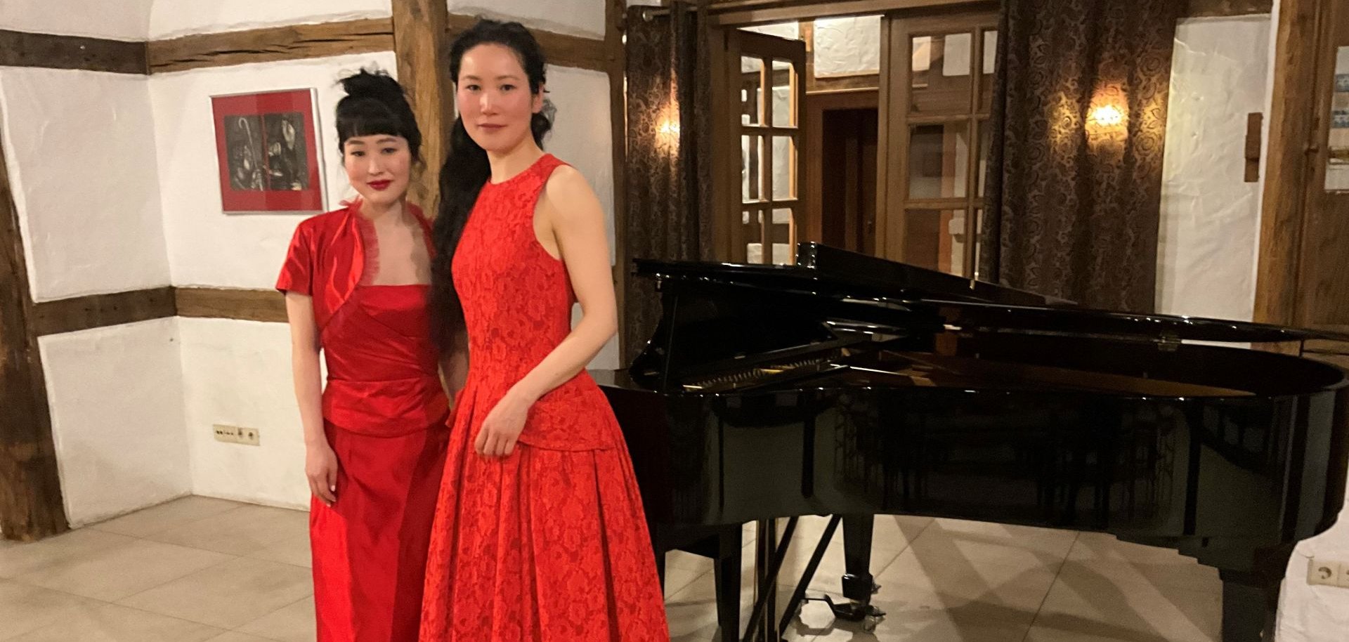 The two musicians in front of the grand piano in the old vicarage