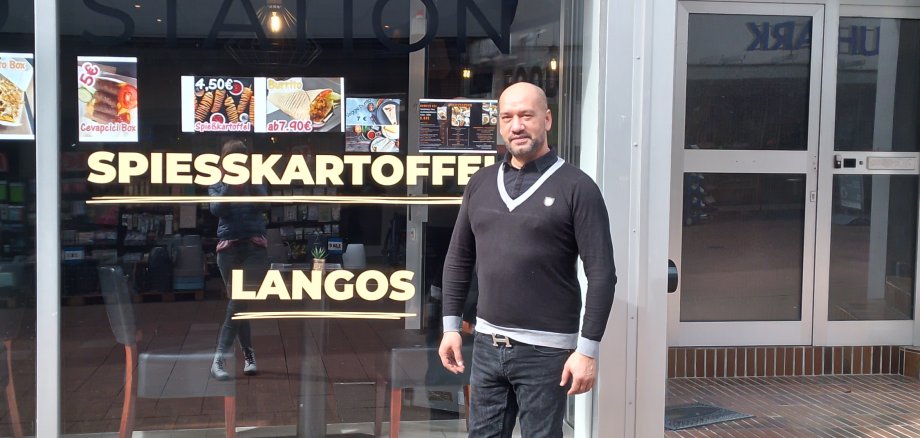 Owner in front of his shop