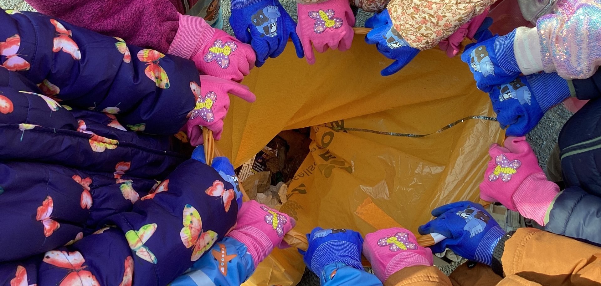 Children's hands on bin liners
